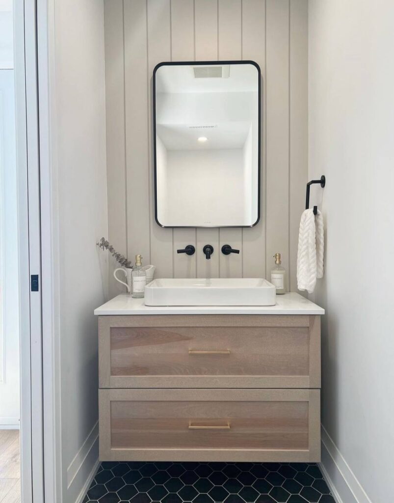 Small bathroom with a floating wood vanity and vertical shiplap wall