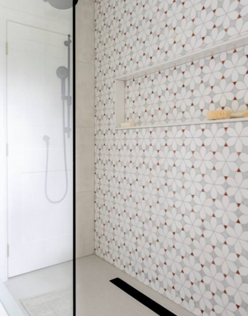Curbless shower with a linear drain and patterned tile wall