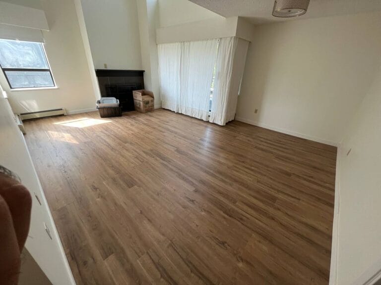 Living room with new warm-toned plank flooring
