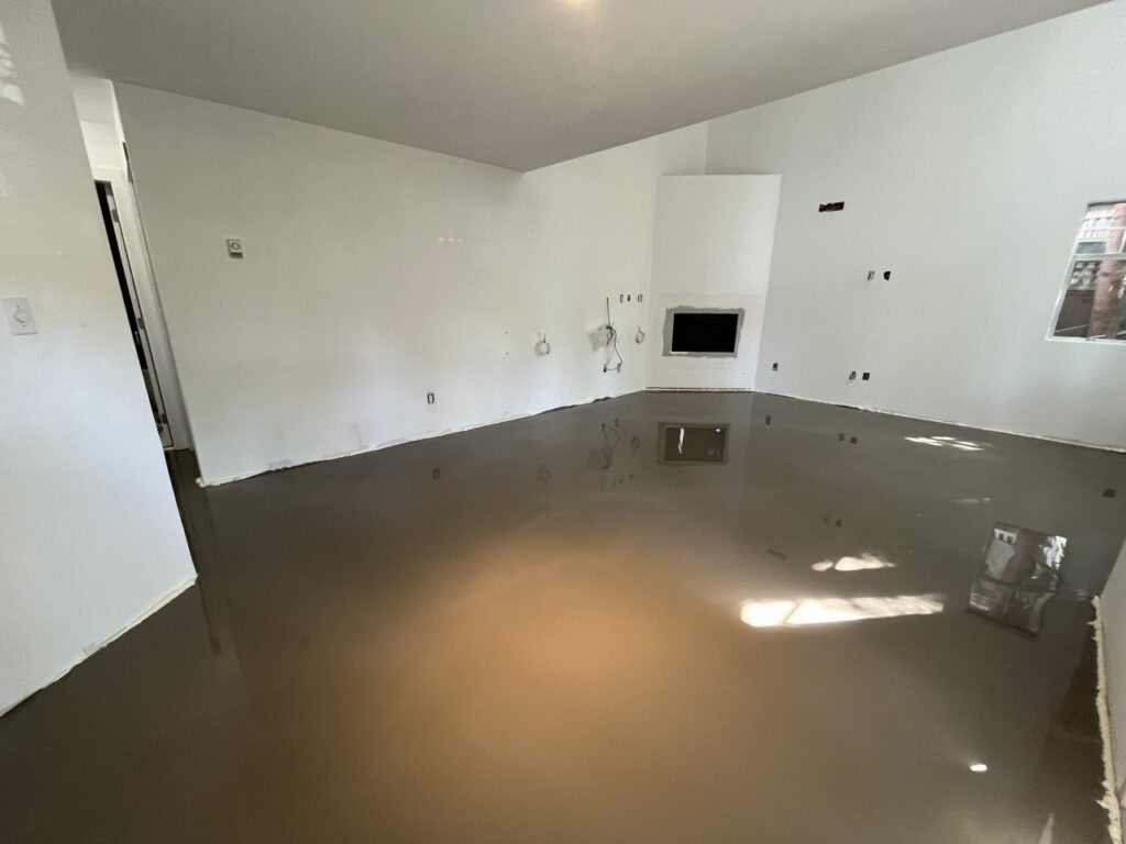 Self-levelling compound poured over a subfloor before new flooring