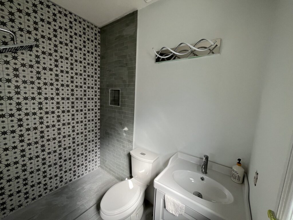 Bathroom with patterned feature tile, new vanity and toilet