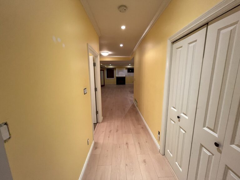 Hallway with new doors, flooring and warm lighting