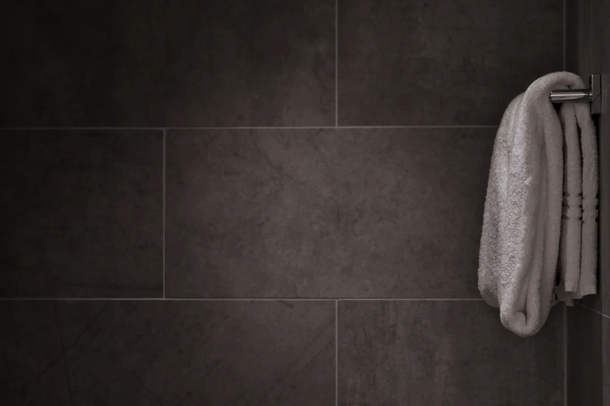 Tiled bathroom showing a contained shower zone