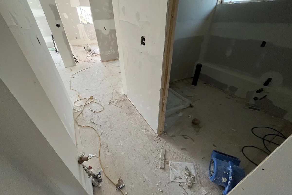 Lower-level renovation in progress with framing, wiring and drywall underway