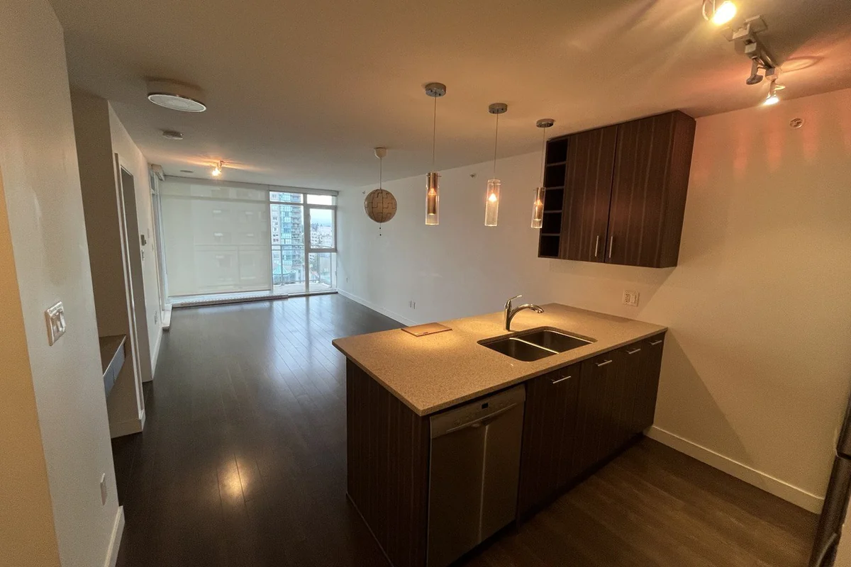 Renovated condo with a kitchen island, pendant lights and new flooring
