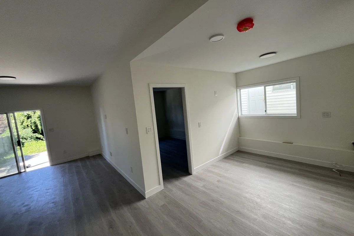 Finished secondary suite with a smoke alarm, new flooring and a separate bedroom