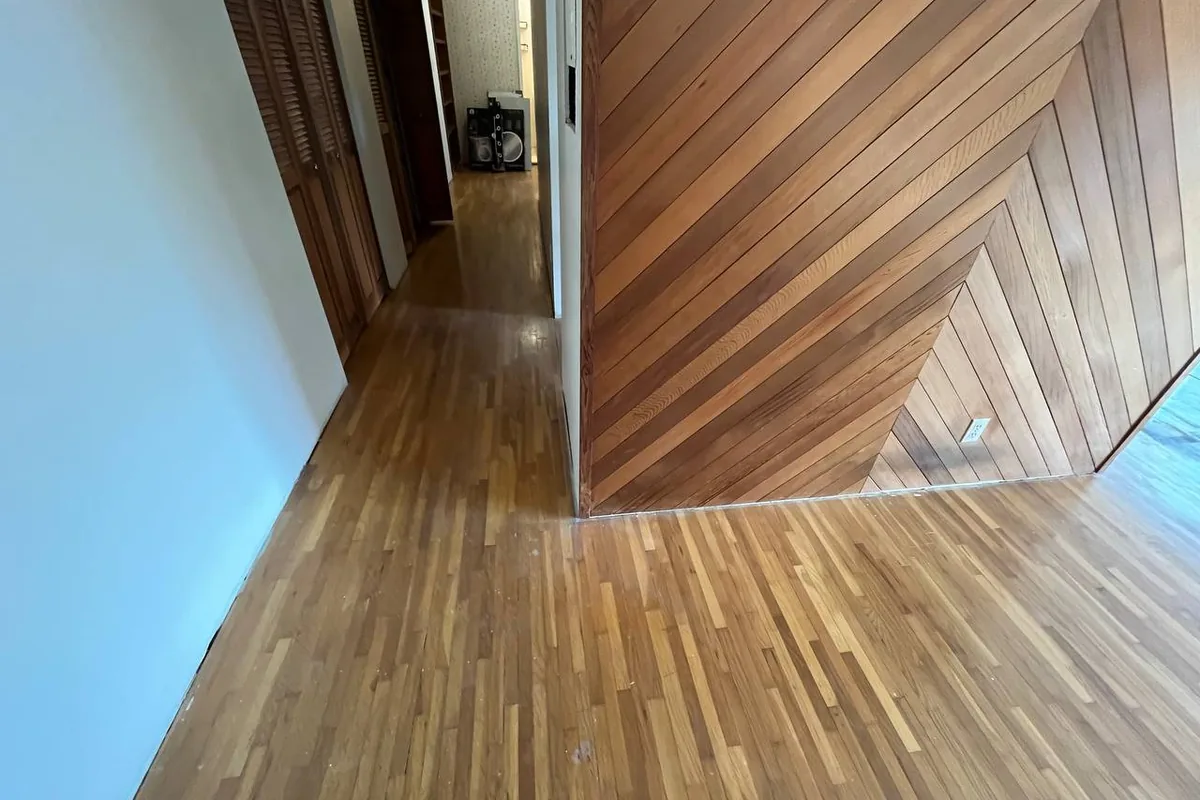 Narrow-strip hardwood flooring running down a hallway